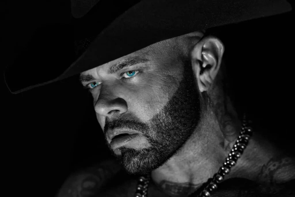 Struggle Jennings in a black cowboy hat, black-and-white portrait