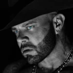 Struggle Jennings in a black cowboy hat, black-and-white portrait