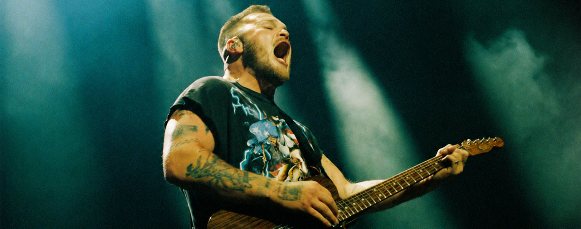 Zach Bryan playing guitar in the official 2027 Young Manhood and Other Donatable Organs Tour artwork